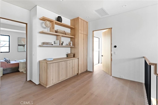 corridor with light hardwood / wood-style floors