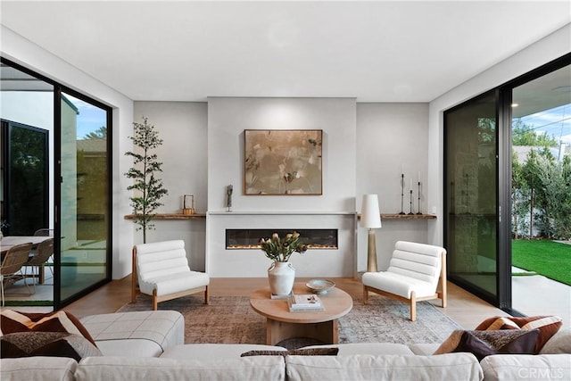 living room with plenty of natural light and light hardwood / wood-style flooring