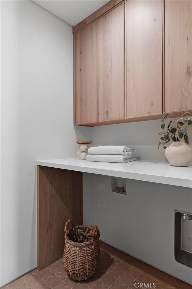 washroom with cabinets, hookup for a washing machine, and tile patterned flooring