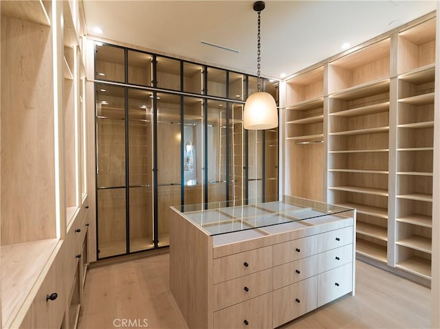 walk in closet featuring light hardwood / wood-style flooring