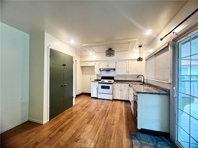 kitchen featuring sink, white electric range oven, white cabinets, decorative light fixtures, and light wood-type flooring