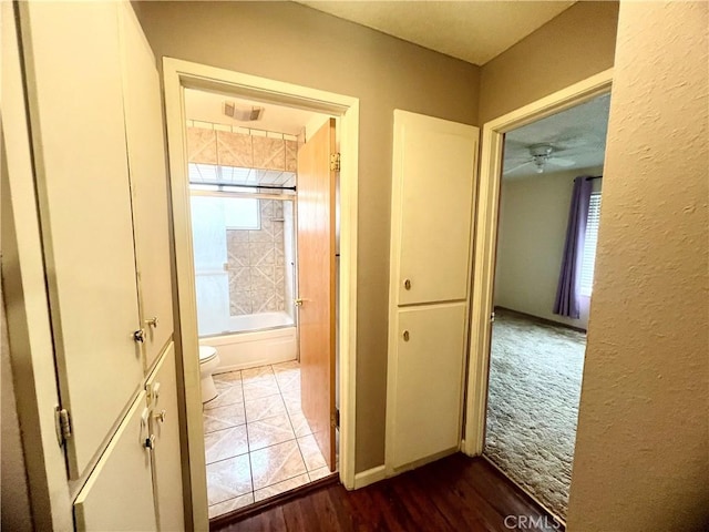 hall with dark tile patterned floors