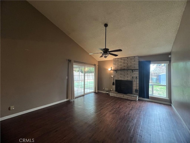 unfurnished living room featuring dark wood-type flooring, ceiling fan, high vaulted ceiling, a fireplace, and a textured ceiling