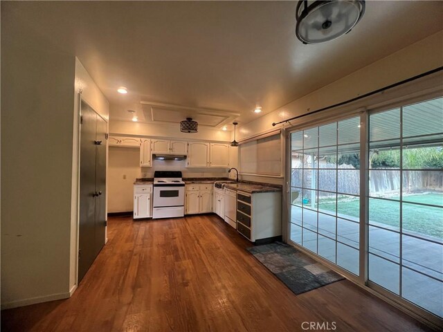 kitchen with white cabinetry, dark wood-type flooring, sink, and white appliances