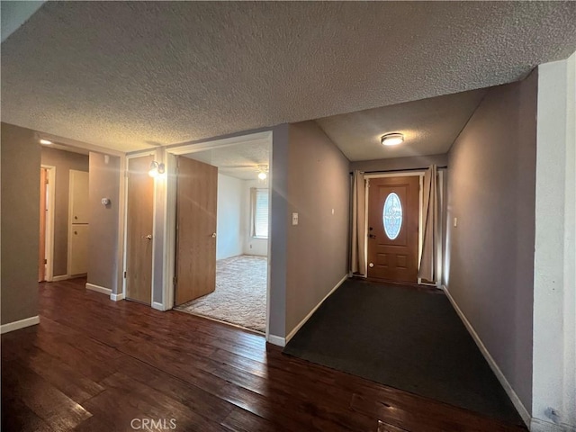 entryway with dark hardwood / wood-style flooring and a textured ceiling