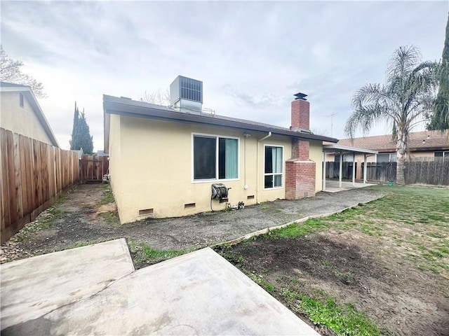 rear view of property featuring cooling unit and a patio area