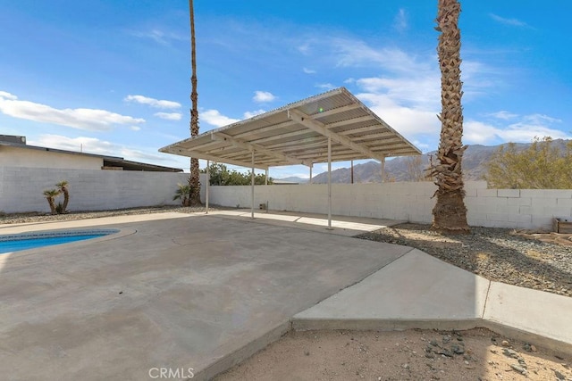 view of vehicle parking with a fenced in pool