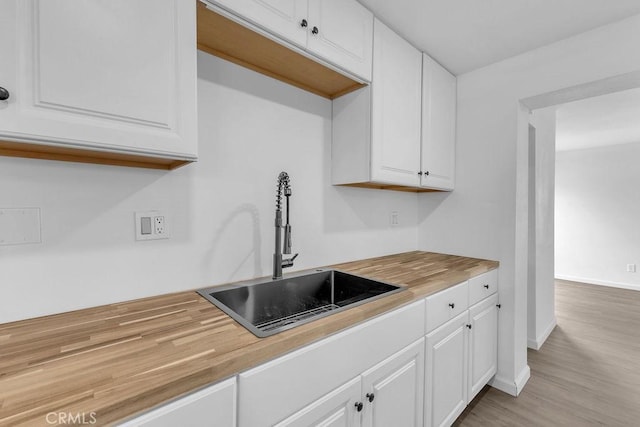 kitchen featuring white cabinets and sink