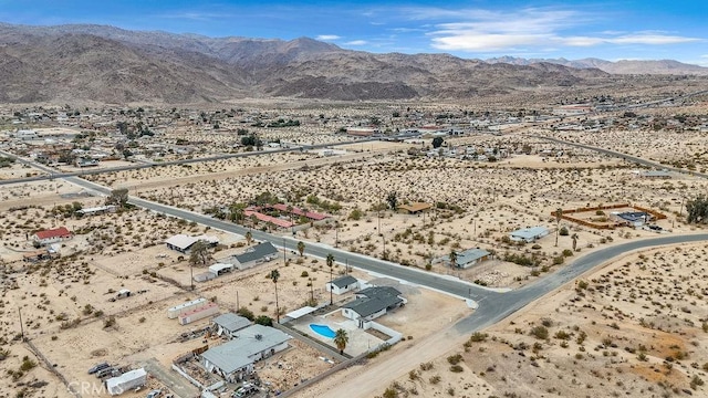 birds eye view of property with a mountain view