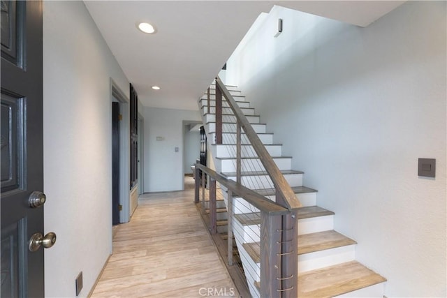 stairs featuring recessed lighting and wood finished floors