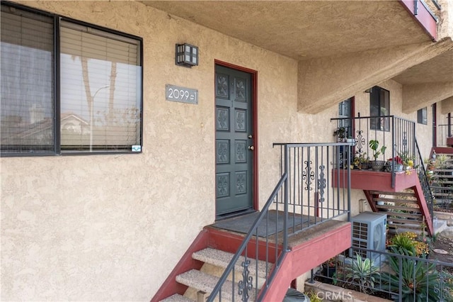 property entrance with stucco siding