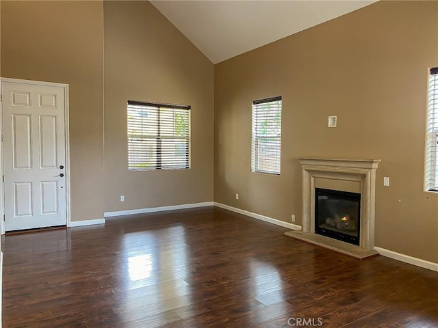 unfurnished living room with dark hardwood / wood-style floors and high vaulted ceiling