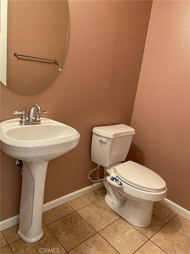 bathroom featuring tile patterned flooring and toilet