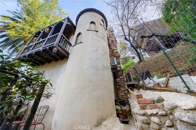 view of side of property with a balcony