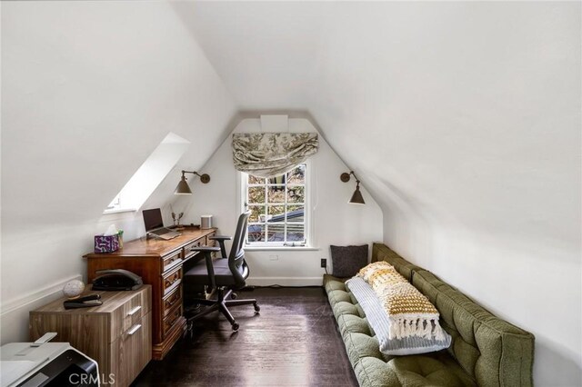 office space featuring dark wood-type flooring and lofted ceiling with skylight