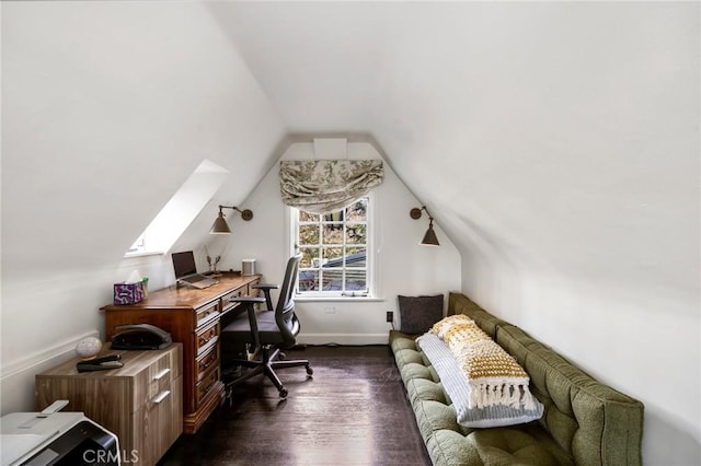 office space featuring dark wood-type flooring and vaulted ceiling with skylight