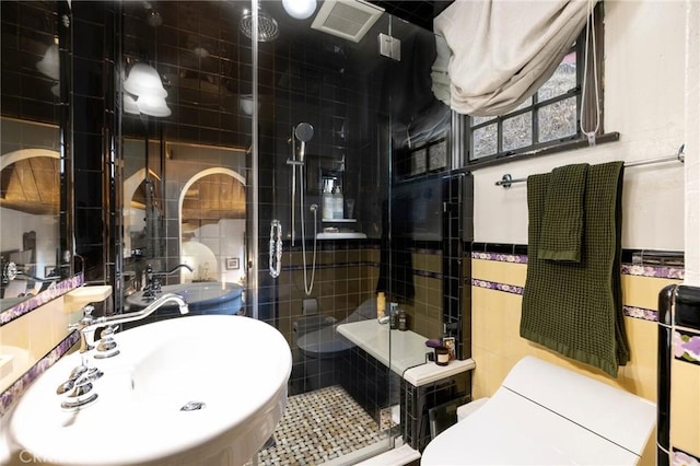 bathroom featuring tile walls, sink, and walk in shower