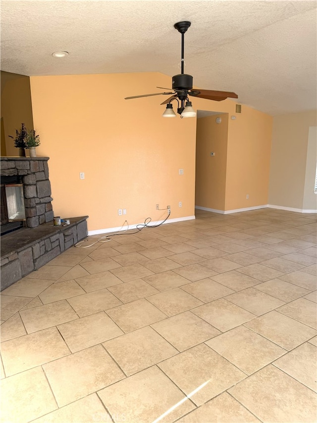 unfurnished living room featuring ceiling fan, a fireplace, and a textured ceiling