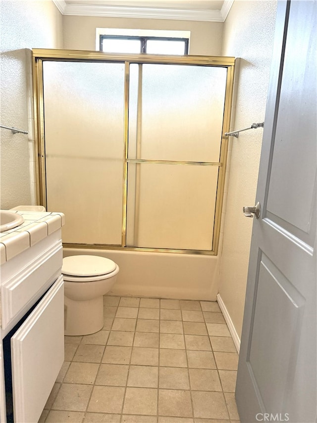 bathroom featuring combined bath / shower with glass door, crown molding, vanity, and toilet