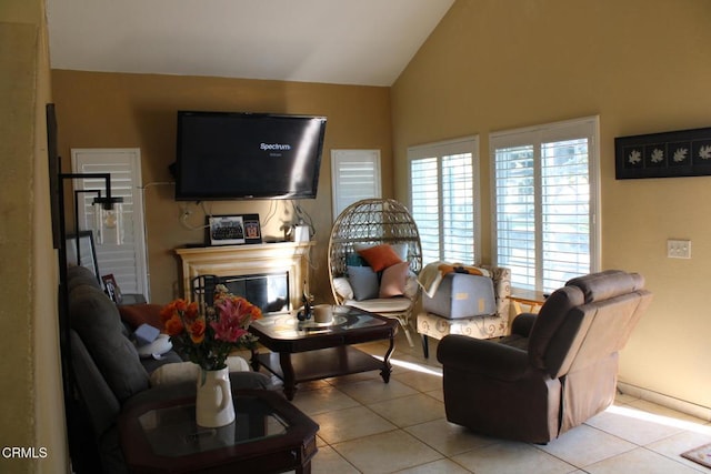 living room featuring vaulted ceiling and light tile patterned floors