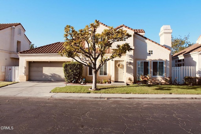 mediterranean / spanish-style home with a garage