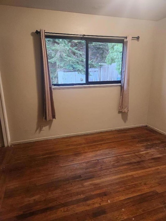 spare room featuring dark hardwood / wood-style flooring