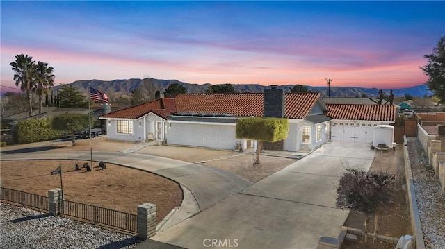 view of front of home with a garage and a mountain view