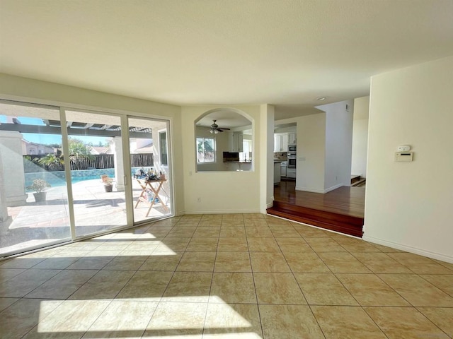 spare room featuring light tile patterned flooring and ceiling fan