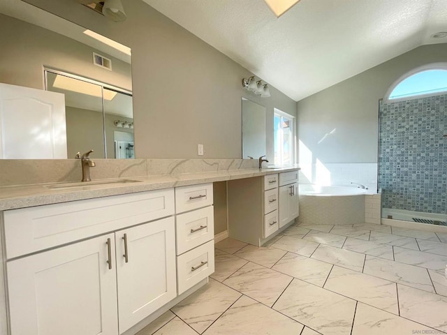 bathroom featuring vanity, vaulted ceiling, and shower with separate bathtub