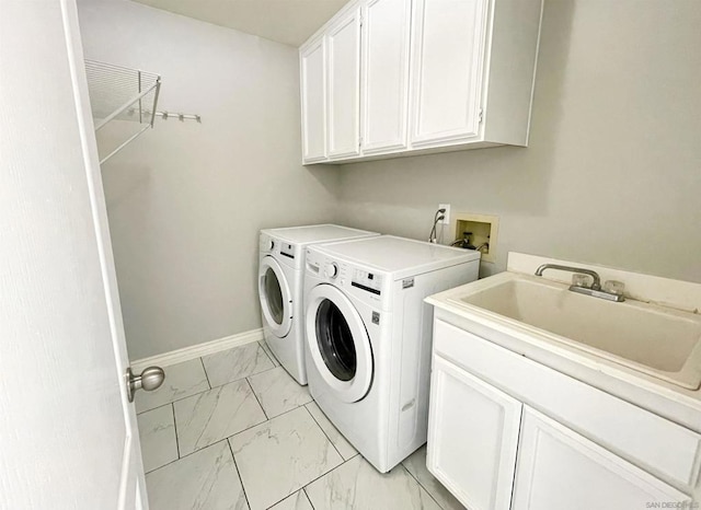 laundry area with cabinets, sink, and washer and dryer