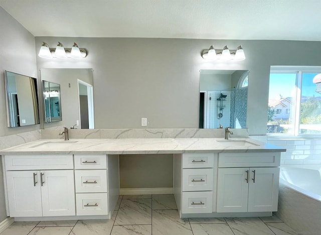 bathroom with vanity and separate shower and tub