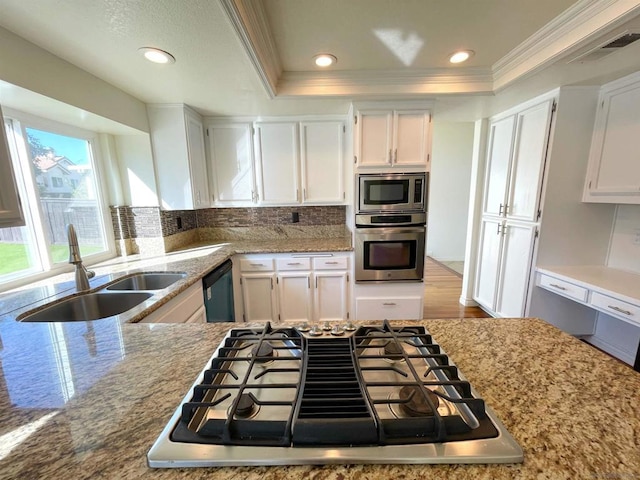 kitchen featuring white cabinetry, stainless steel appliances, sink, and backsplash