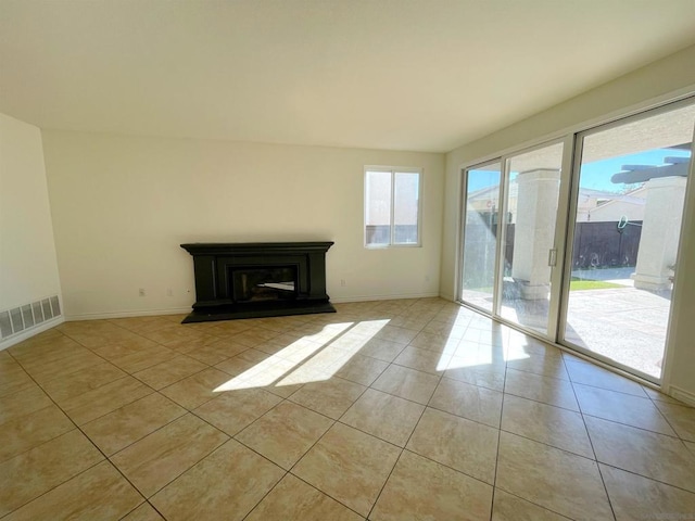 unfurnished living room featuring light tile patterned floors