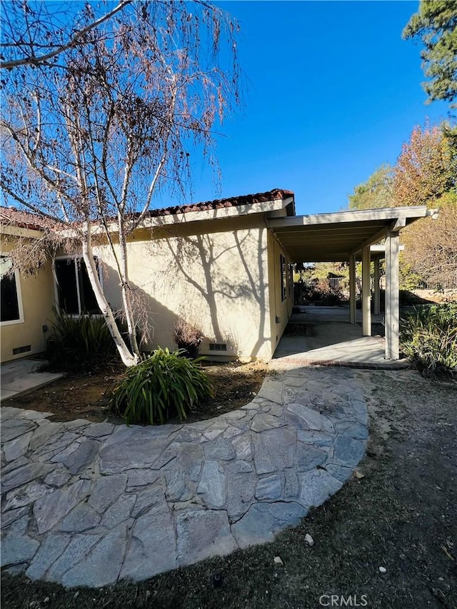 view of home's exterior featuring a carport