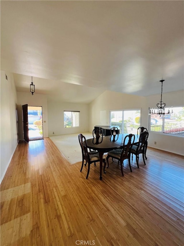 dining room featuring an inviting chandelier and light hardwood / wood-style flooring