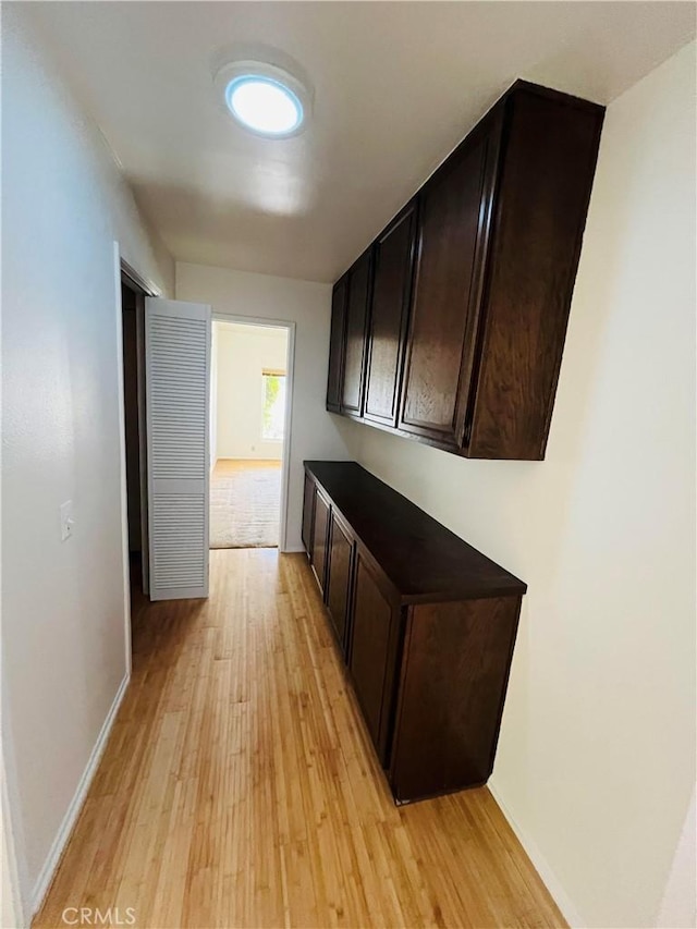 corridor with light hardwood / wood-style floors