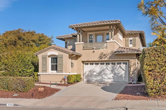 mediterranean / spanish-style house featuring a balcony and a garage