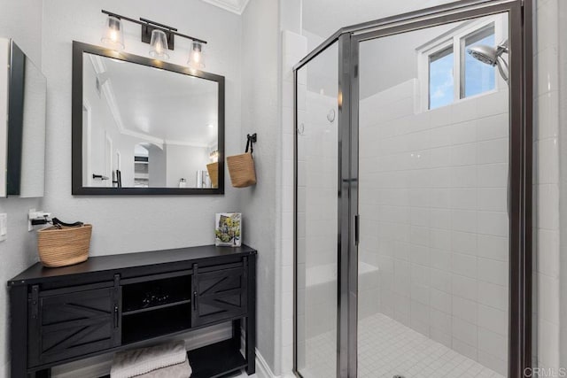 bathroom with a shower with door, ornamental molding, and vanity