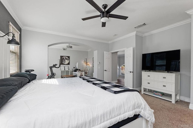 bedroom with ceiling fan, ornamental molding, and carpet flooring