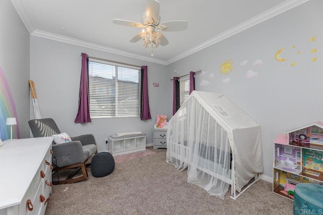 carpeted bedroom featuring a crib, ornamental molding, and ceiling fan