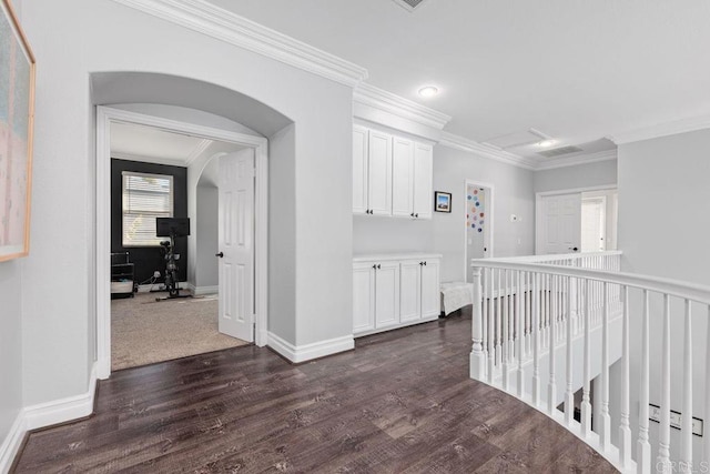 hallway featuring ornamental molding and dark wood-type flooring