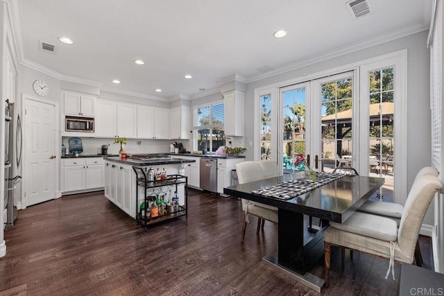 kitchen featuring white cabinetry, stainless steel appliances, and a kitchen island