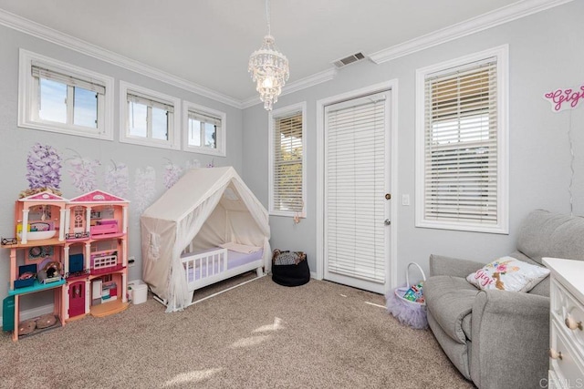 carpeted bedroom with crown molding, a chandelier, and a crib