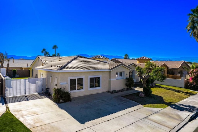 ranch-style house with a mountain view and a front yard