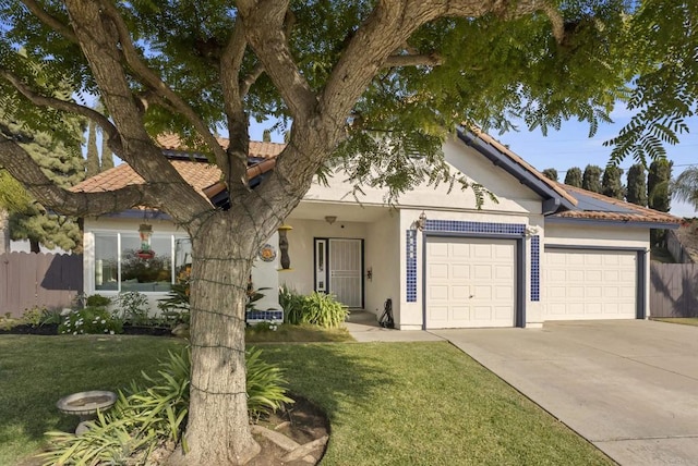 view of front of home with a garage and a front yard