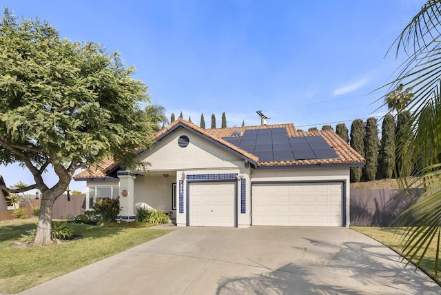 ranch-style house featuring a garage, a front lawn, and solar panels