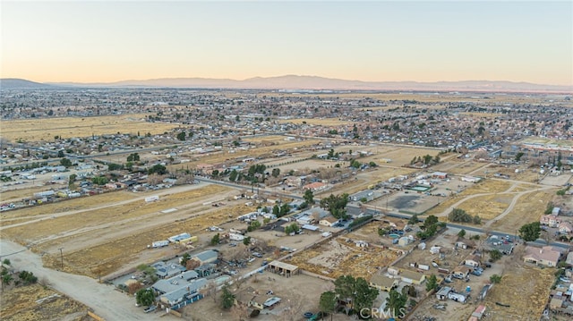 aerial view at dusk featuring a mountain view