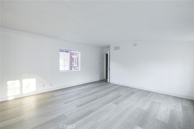 unfurnished room with light hardwood / wood-style floors