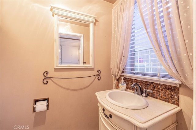 bathroom with vanity and decorative backsplash