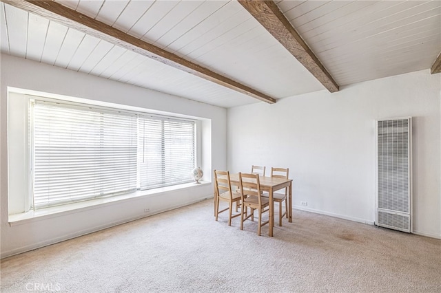 dining room featuring carpet floors and beamed ceiling